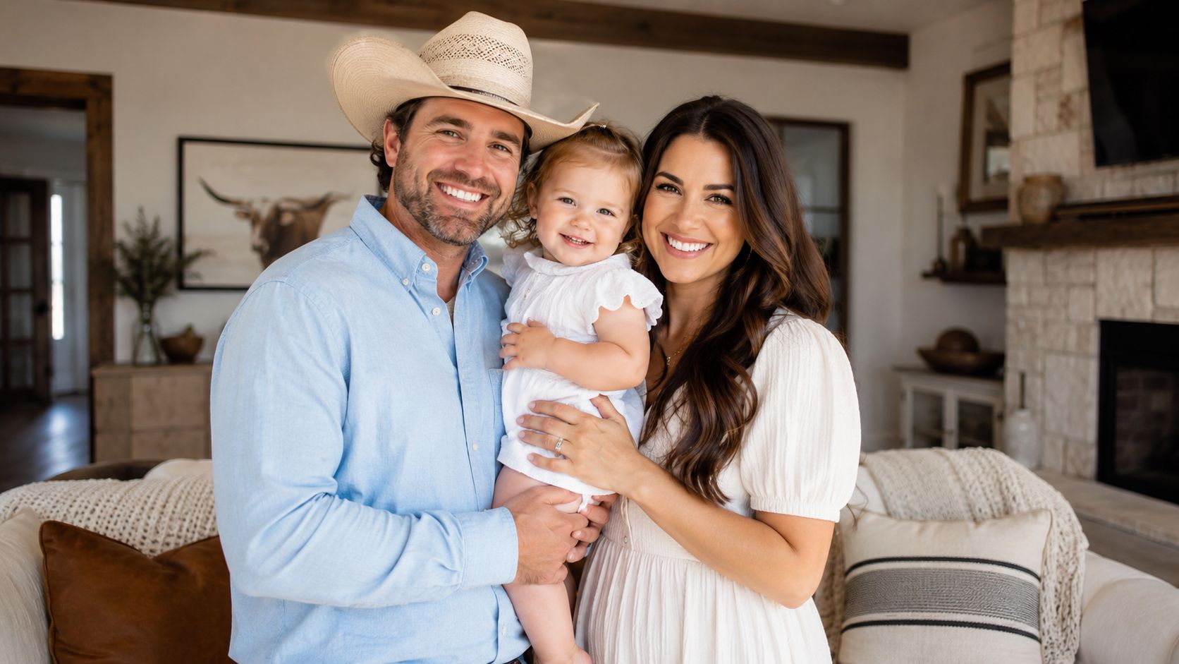 A happy family consisting of a father in a cowboy hat, a mother, and their young toddler.